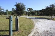Photo: 7, ROSS PRAIRIE. View of campsite with electric hookups. A picnic table and fire ring can be seen.