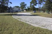 Photo: 7, ROSS PRAIRIE. View of campsite with electric hookups. A picnic table and fire ring can be seen.