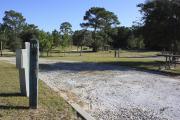 Photo: 10, Loop P. View of campsite with electric hookup. A picnic table can be seen in the background.