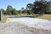 Photo: 10, Loop P. View of campsite with electric hookup. A picnic table can be seen in the background.