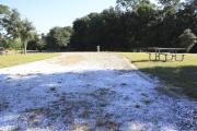 Photo: 12, Loop B. View of site with electric and water hookups and picnic table.