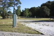 Photo: 13, Loop B. View of campsite with electric hookup. A picnic table can be seen in the background.