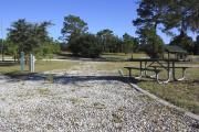 Photo: 14, Loop B. View of campsite with electric hookup and picnic table.