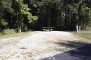 Photo: 001, SANTOS CAMPGROUND. View of campsite with water and electric hookups and picnic table with fire ring.