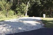 Photo: 003, SANTOS CAMPGROUND. View of campsite with water and electric hookups and picnic table with fire ring.