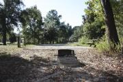 Photo: 003, SANTOS CAMPGROUND. View of campsite with water and electric hookups and picnic table with fire ring.