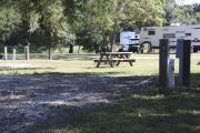 Photo: 004, SANTOS CAMPGROUND. View of campsite with water and electric hookups and picnic table with fire ring.
