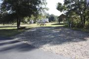 Photo: 004, SANTOS CAMPGROUND. View of campsite with water and electric hookups and picnic table with fire ring.