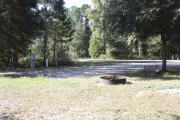 Photo: 004, SANTOS CAMPGROUND. View of campsite with water and electric hookups and picnic table with fire ring.