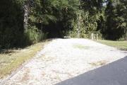 Photo: 006, SANTOS CAMPGROUND. View of campsite with water and electric hookups and picnic table with fire ring.