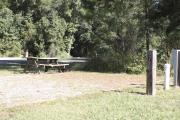 Photo: 007, SANTOS CAMPGROUND. View of campsite with water and electric hookups and picnic table with fire ring.