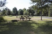Photo: 007, SANTOS CAMPGROUND. View of campsite with water and electric hookups and picnic table with fire ring.