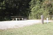 Photo: 008, SANTOS CAMPGROUND. View of campsite with water and electric hookups and picnic table with fire ring.