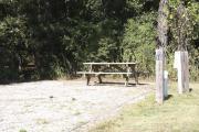 Photo: 010, SANTOS CAMPGROUND. View of campsite with water and electric hookups and picnic table with fire ring.