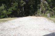Photo: 010, SANTOS CAMPGROUND. View of campsite with water and electric hookups and picnic table with fire ring.