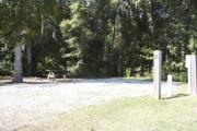 Photo: 012, SANTOS CAMPGROUND. View of campsite with water and electric hookups and picnic table with fire ring.