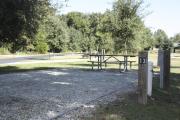 Photo: 013, SANTOS CAMPGROUND. View of campsite with water and electric hookups and picnic table with fire ring.