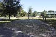 Photo: 013, SANTOS CAMPGROUND. View of campsite with water and electric hookups and picnic table with fire ring.