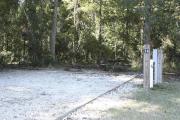 Photo: 014, SANTOS CAMPGROUND. View of campsite with water and electric hookups and picnic table with fire ring.