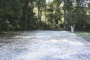 Photo: 014, SANTOS CAMPGROUND. View of campsite with water and electric hookups and picnic table with fire ring.