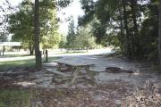 Photo: 014, SANTOS CAMPGROUND. View of campsite with water and electric hookups and picnic table with fire ring.