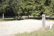 Photo: 015, SANTOS CAMPGROUND. View of campsite with water and electric hookups and picnic table with fire ring.