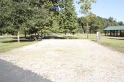 Photo: 015, SANTOS CAMPGROUND. View of campsite with water and electric hookups and picnic table with fire ring.