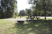 Photo: 015, SANTOS CAMPGROUND. View of campsite with water and electric hookups and picnic table with fire ring.