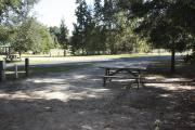 Photo: 016, SANTOS CAMPGROUND. View of campsite with water and electric hookups and picnic table with fire ring.