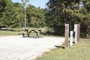 Photo: 017, SANTOS CAMPGROUND. View of campsite with water and electric hookups and picnic table with fire ring.
