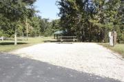 Photo: 017, SANTOS CAMPGROUND. View of campsite with water and electric hookups and picnic table with fire ring.
