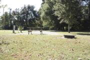 Photo: 017, SANTOS CAMPGROUND. View of campsite with water and electric hookups and picnic table with fire ring.
