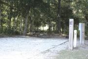 Photo: 018, SANTOS CAMPGROUND. View of campsite with water and electric hookups and picnic table with fire ring.