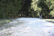 Photo: 018, SANTOS CAMPGROUND. View of campsite with water and electric hookups and picnic table with fire ring.