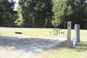 Photo: 019, SANTOS CAMPGROUND. View of campsite with water and electric hookups and picnic table with fire ring.