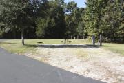 Photo: 019, SANTOS CAMPGROUND. View of campsite with water and electric hookups and picnic table with fire ring.