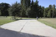 Photo: 020, SANTOS CAMPGROUND. ADA accessible site with concrete pad, water and electric hookups and picnic table with fire ring.