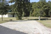 Photo: 021, SANTOS CAMPGROUND. View of campsite with water and electric hookups and picnic table with fire ring.