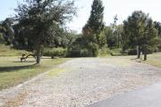 Photo: 023, SANTOS CAMPGROUND. View of campsite with water and electric hookups and picnic table with fire ring.